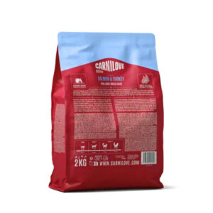 Bag of Carnilove Salmon & Turkey cat food (2 kg), red package with blue top and detailed labeling visible on the back panel.