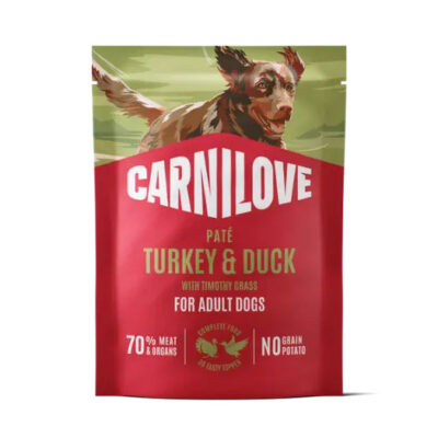 Carnilove dog food bag for adult dogs, turkey & duck flavor, shows a dog image on top with bold red packaging and claims 70% meat and no grain